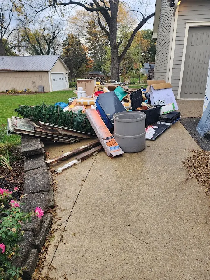 Dumpster being loaded with debris for Estate Cleanout Dumpster Rental in London